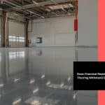 An empty warehouse with a shiny floor made of chemical resistant epoxy flooring.