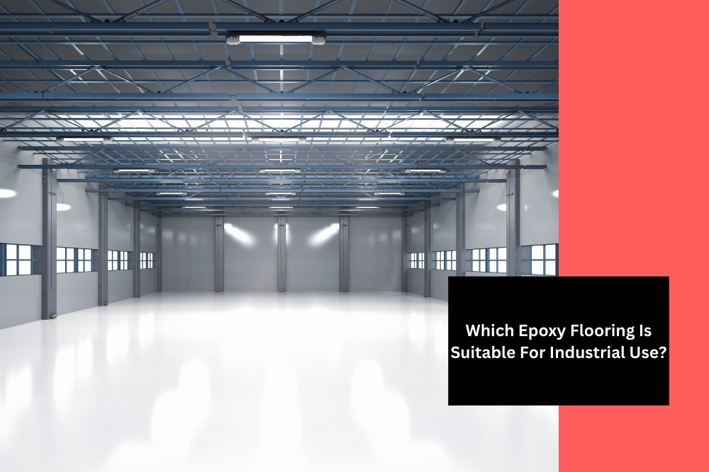 Spacious industrial warehouse with high ceilings, featuring pristine white epoxy flooring for industrial use, illuminated by natural light from multiple windows and overhead lights. The image highlights the suitability of epoxy flooring for large industrial spaces.