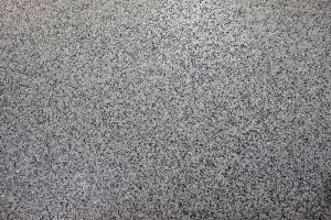 An epoxy flake floor in dark grey tones, highlighting one of the popular epoxy flake floor colours for modern interiors.