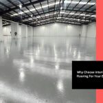 spacious industrial warehouse with smooth grey interior epoxy flooring and high ceilings, offering a durable and polished finish