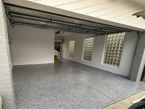 Light grey epoxy flooring colours in a modern garage, enhancing brightness and creating a clean, polished appearance.