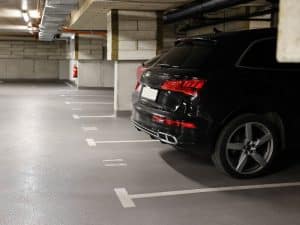 Close-up of line marking paint for car parks, highlighting designated parking spaces in an indoor epoxy-floored garage.