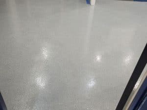 Seamless grey epoxy flooring for corridors, offering durability and a polished finish for commercial and industrial spaces.