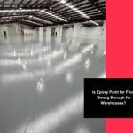 Spacious warehouse with glossy grey epoxy paint for floor and high ceilings.