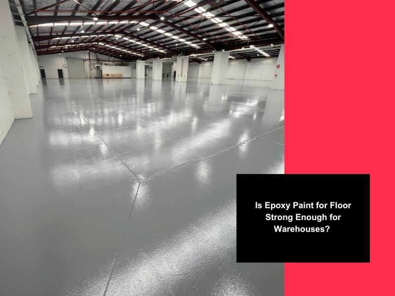 Spacious warehouse with glossy grey epoxy paint for floor and high ceilings.