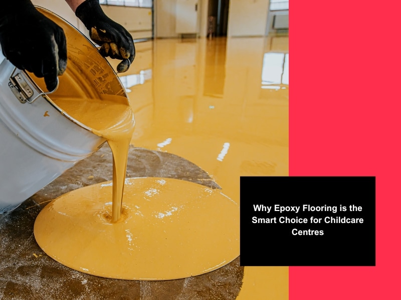Worker pouring yellow epoxy resin onto a floor during installation of child friendly flooring in a childcare centre.