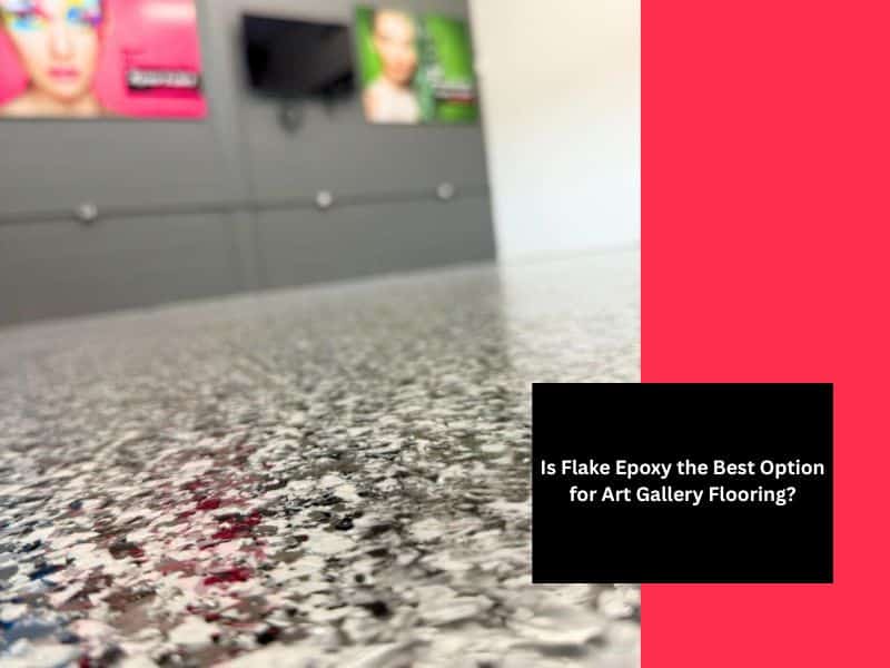 Close-up of black and white flake epoxy art gallery flooring in a modern exhibition space with bright wall art.
