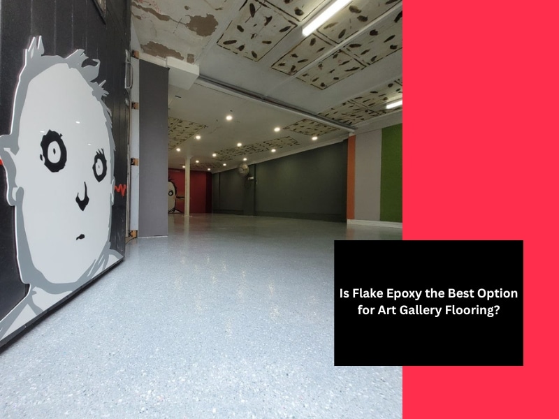 Wide shot of a modern art gallery with flake epoxy art gallery flooring, painted mural wall and overhead lighting.