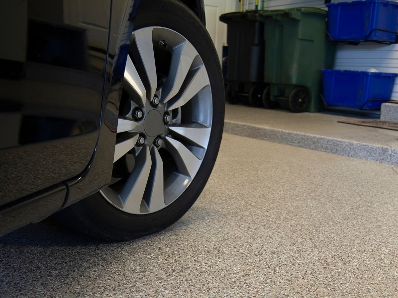 finished result after putting epoxy on garage floor under car tire