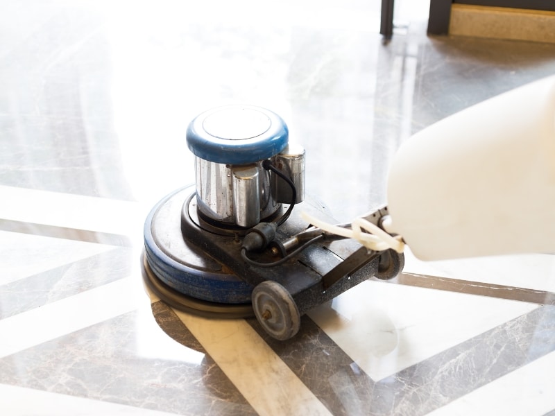 Polishing old concrete floors using a professional floor buffer machine for enhanced smoothness and shine.