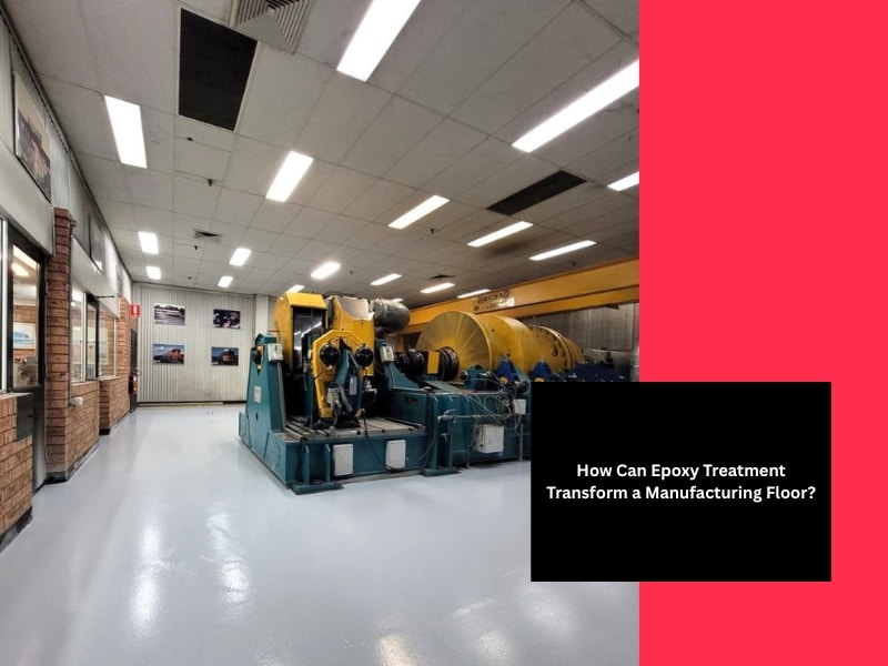 Polished manufacturing floor with heavy machinery after epoxy treatment, showing smooth reflective surface and bright overhead lighting.
